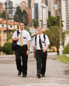 Two Mormon missionaries walking down the street.